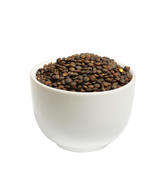 Bowl of dry  french green puy lentils, isolated